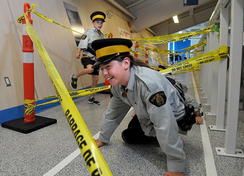 MARIO BARTEL/THE TRI-CITY NEWS
Junior Mounties negotiate a maze of police tape at their annual police academy at the Poirier Sports and Leisure Complex on Wednesday. The academy, put on my Coquitlam RCMP, gives nearly 100 young people a taste of various police skills at a boot camp, learn investigative skills and even try on police gear.