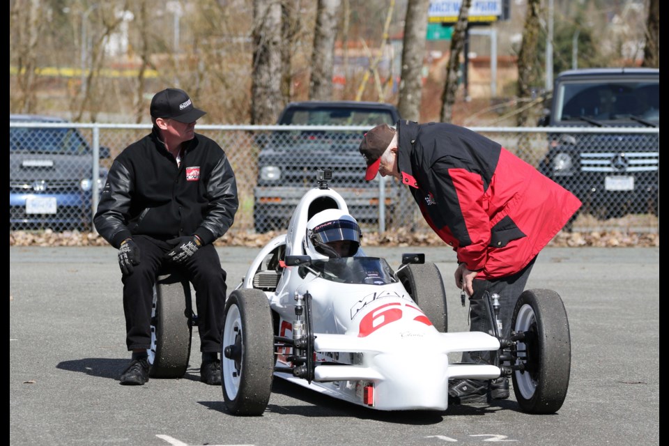 Burnaby’s Al Ores, at right, talks racing with grandson Robbie Arthur, in his Formula Vee racer. Ores will take to Mission Raceway this weekend for a special event, the B.C. Historic Motor Races, with the senior racer celebrating 50 years and counting in the driver’s seat.
