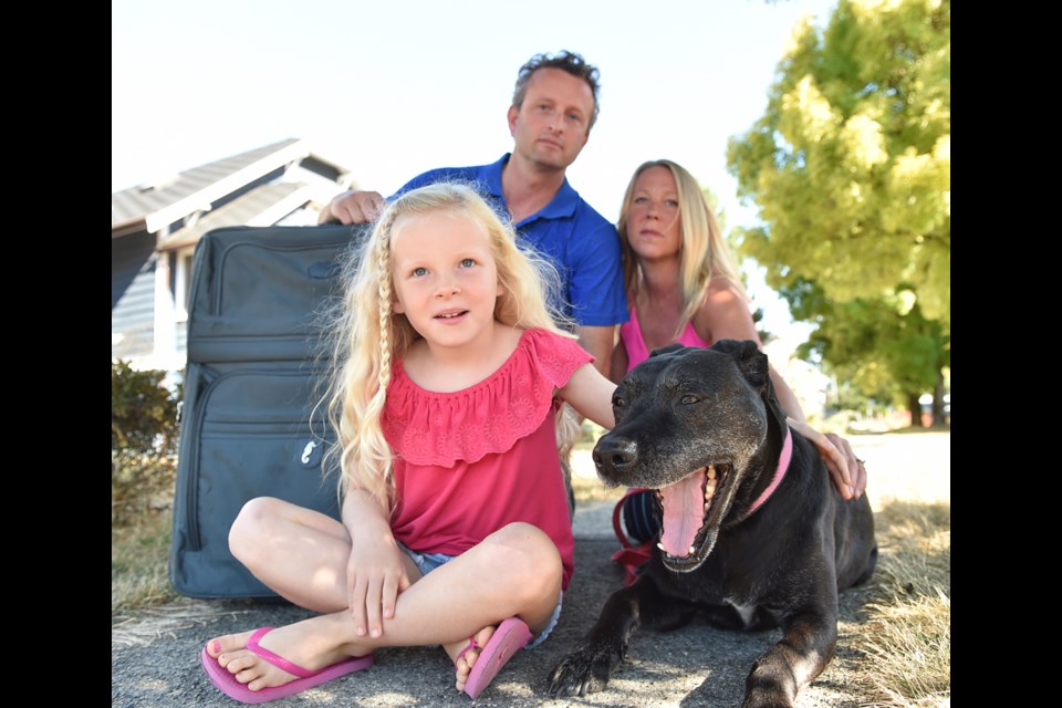 Byran Stewart with wife Andrea Robbie, daughter Sadie, 6, and their dog Maggie, 12. “I have a good job here. But at some point you say, good job or not, what’s left over is not enough," Stewart said. Photo Dan Toulgoet