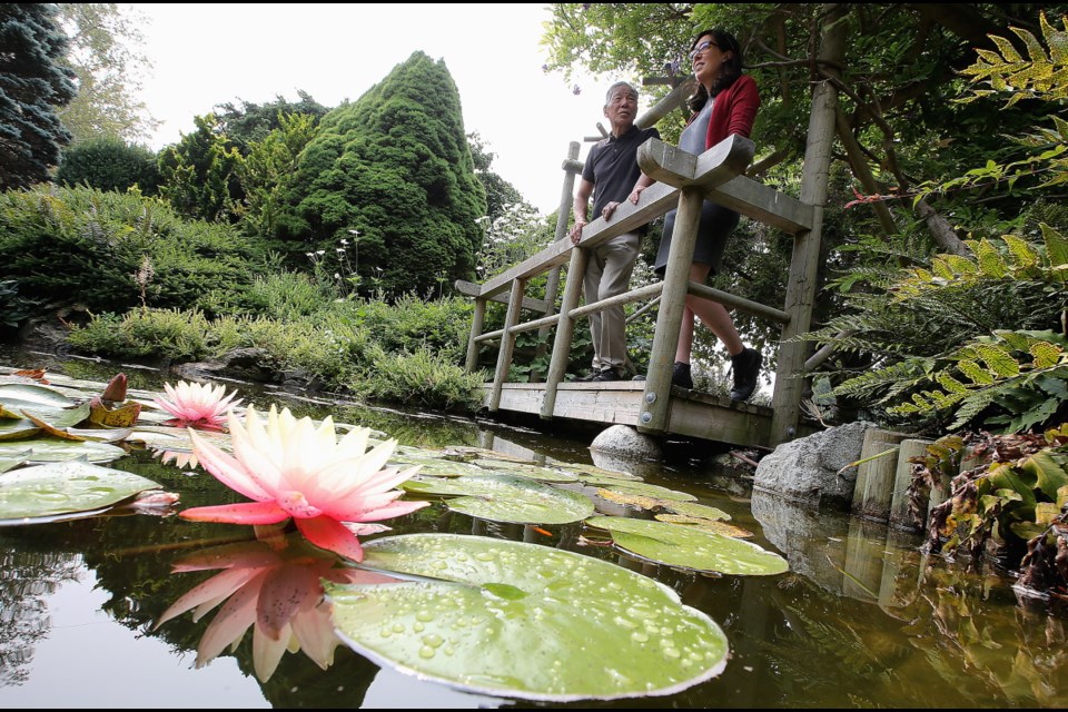 Tsugio Kurushima, president of the Victoria Nikkei Cultural Society, and researcher Kaitlin Findlay in the garden.