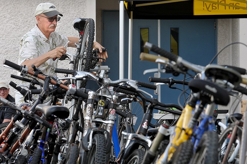 Al Olson has a lot of work ahead of him as he fixes up bikes to get them ready to be sold at the semi-annual KidSport used equipment sale on Saturday at the Poirier Forum.
