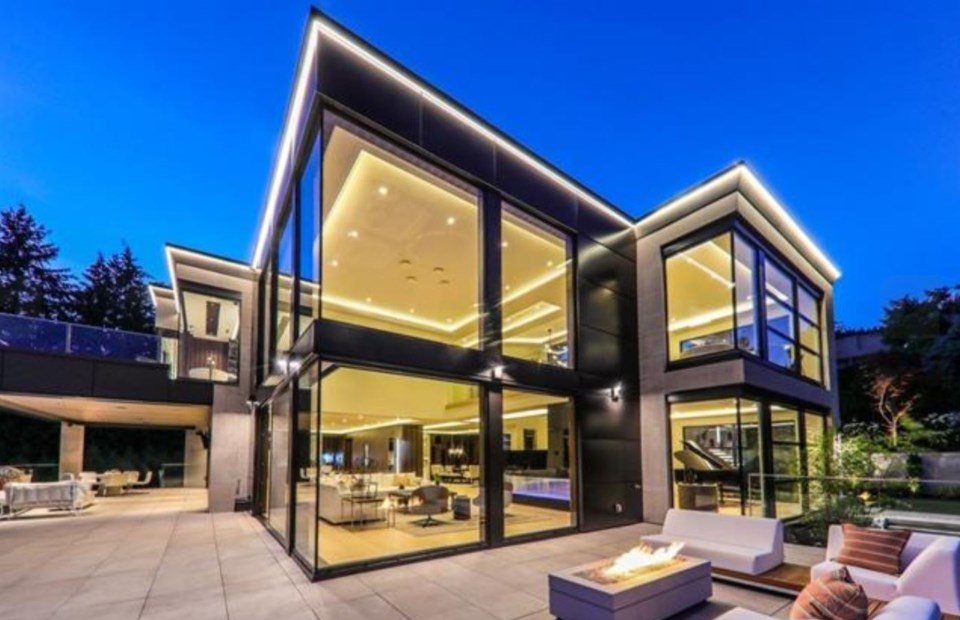 British Properties contemporary mansion exterior at night