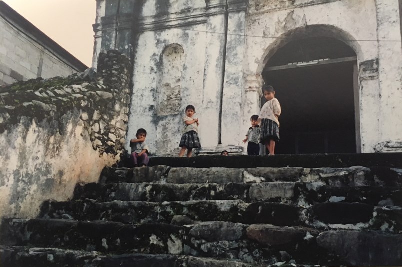 Ancient stairs from a Maya temple lead to a Catholic church built by the Spanish.