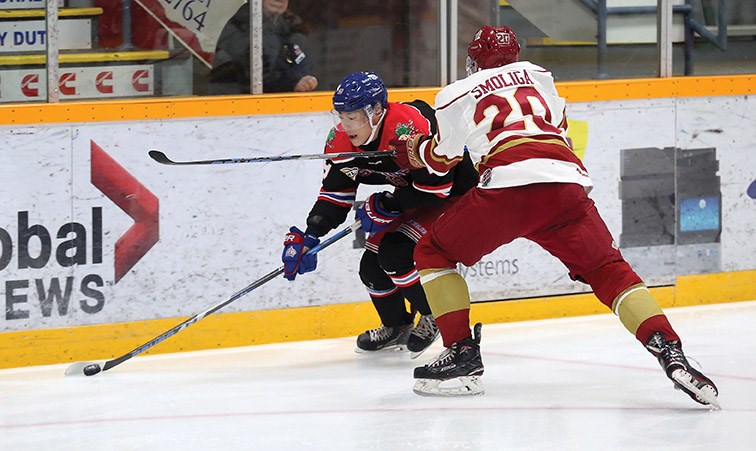 Prince George Spruce Kings forward Chong Min Lee maintains control of the puck while being checked by Chilliwack Chiefs defender Matthew Smoliga on Saturday night at Rolling Mix Concrete Arena. Citizen Photo by James Doyle