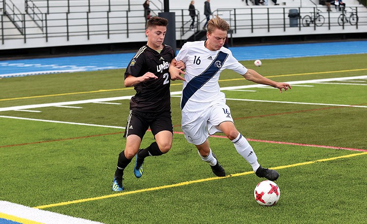 UNBC Timberwolves midfielder Josh McAvoy and Trinity Western University Spartans defender Noah Kroeker battle over a loose ball on Saturday evening at Masich Place Stadium. Citizen Photo by James Doyle