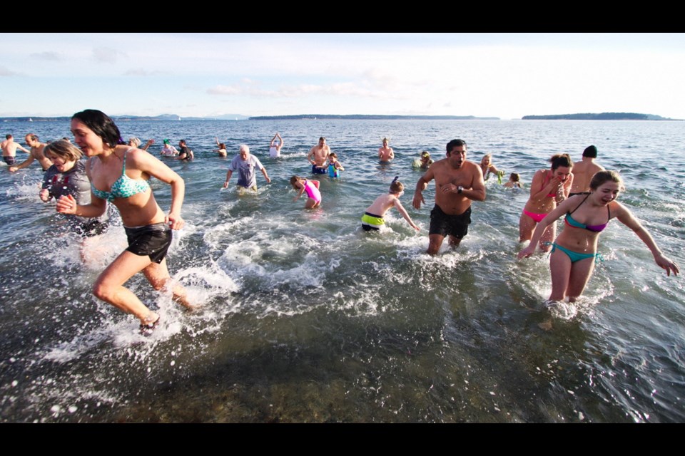 Doughty participants brave the elements during the annual Polar Bear Swim at Tulista Park in Sidney Tuesday. A similar event was held two hours later at Elk Lake.