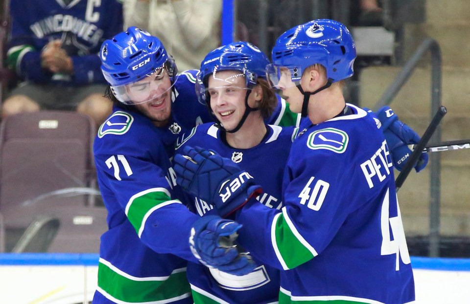 Jonathan Dahlen celebrates a goal with Elias Pettersson and Zack MacEwen at 2018 Young Stars