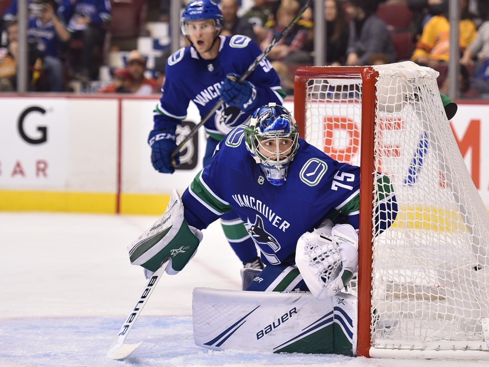 Michael DiPietro holds the post for the Vancouver Canucks in preseason action against the Flames.