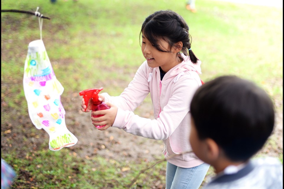 Eight-year-old Somin Lee works on a craft at Rivers Day.