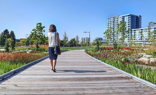 A woman strolls through Aberdeen Park on a sunny day. Photo: Instagram/@visitrichmondbc