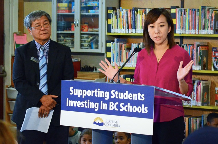 Burnaby-Lougheed MLA and minister of state for childcare Katrina Chen speaks at a seismic announcement at Armstrong Elementary School while Burnaby school board chair Gary Wong looks on.