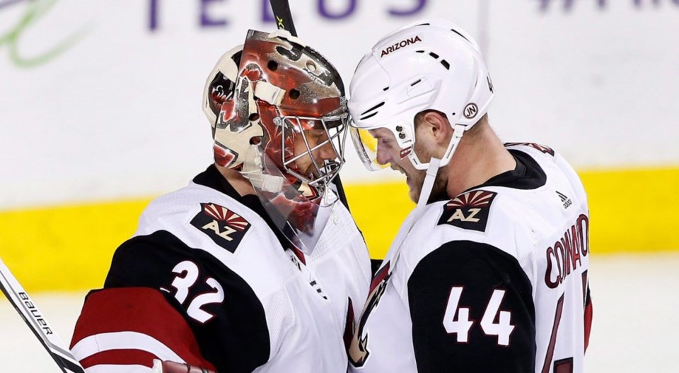 Antti Raanta and Kevin Connauton celebrate a win for the Arizona Coyotes.