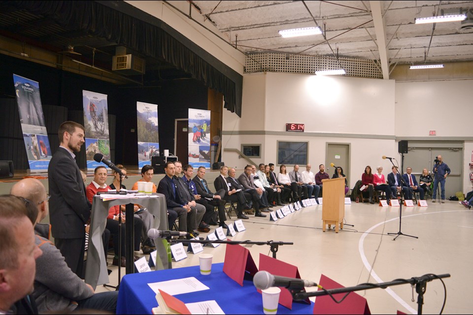 Moderator Doug Munroe addresses the audience at Brennan Park Recreation centre gym on Monday night.