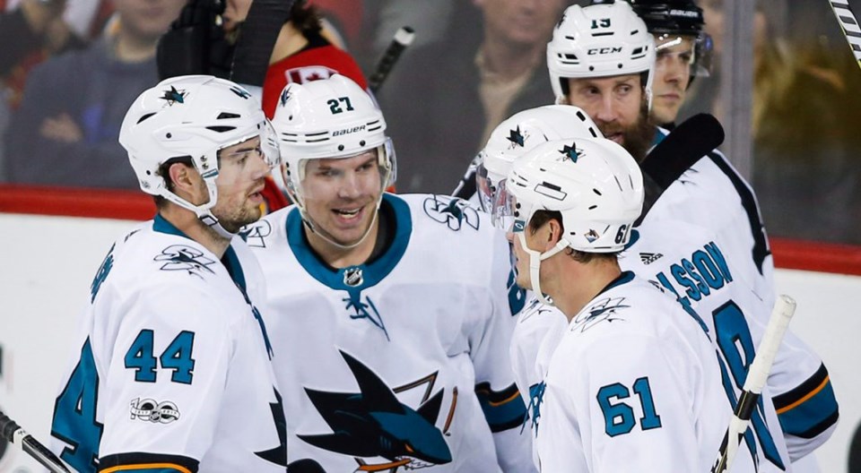 Joonas Donskoi celebrates a goal with his San Jose Sharks teammates.