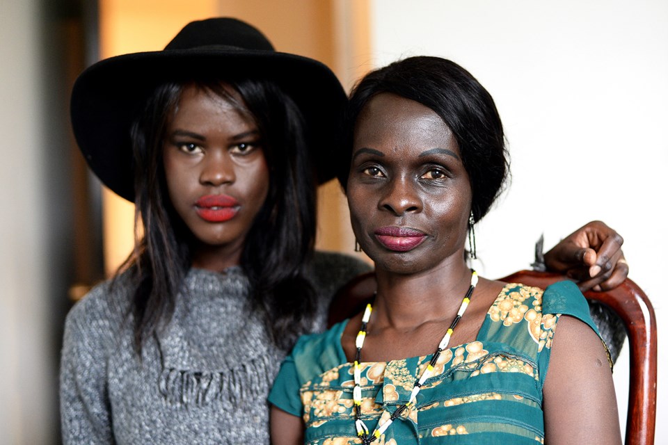 Adhel Arop, left, and her mother Amel Madut in the family's Burnaby apartment. Adhel has earned a $50,000 STORYHIVE grant to make a documentary about the story of her mother - a former fighter in the Sudanese People's Liberation Army - and how it shaped Adhel's own identity.