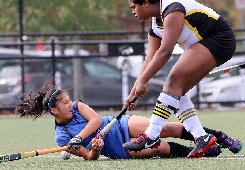 Port Moody Blues forward Alyssa Tong battles Gleneagle Talons' defender Annika Venketash in the first half of their high school senior girls field hockey match, Tuesday at Town Centre Park in Coquitlam. Gleneagle won the match, 2-1, with Natalie Hill scoring both the Talons' goals in her first game back from an injury. Caitlin Miller scored the lone goal for the Blues.
