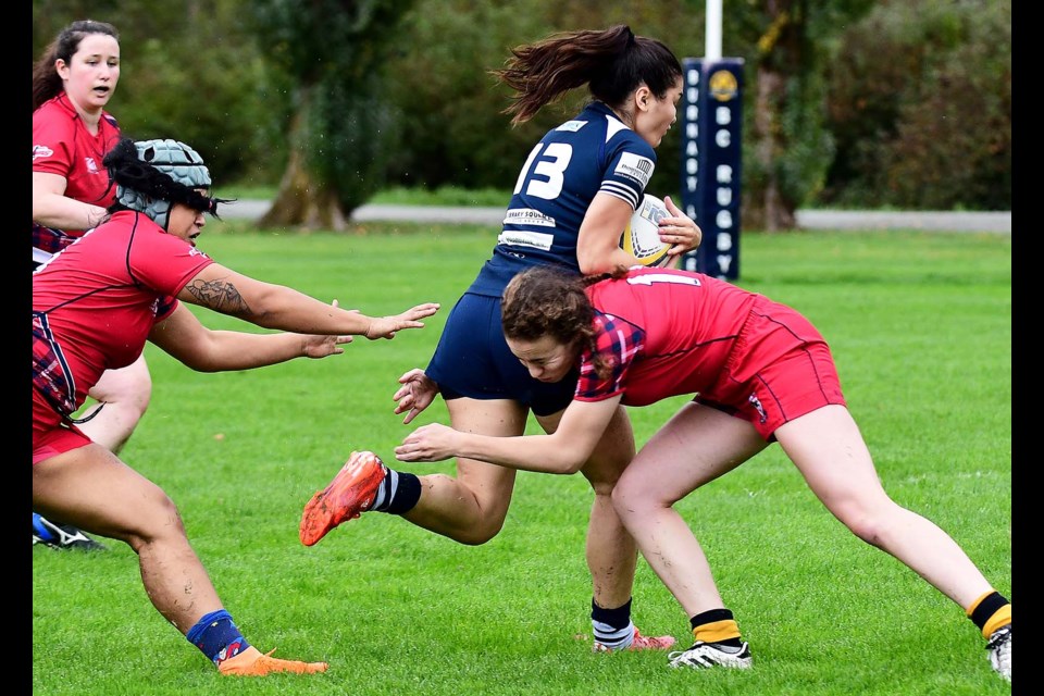 Powering through a tackle for open space, Burnaby Lake's Alya Govorchin motors forward past an SFU defender last week in women's rugby action. Govorchin scored twice in the team's 54-5 victory.