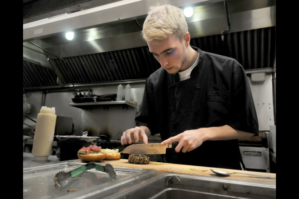 Chef Bryan Brommeland makes a Tuna Tataki burger at The Maplewood Taphouse & Eatery.