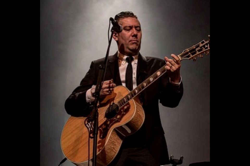 Dave Genn performs with one of the guitars stolen from a vehicle parked in New Westminster last Friday night. Police recovered five of the seven stolen guitars over the weekend, but this guitar and another acoustic one are still missing.