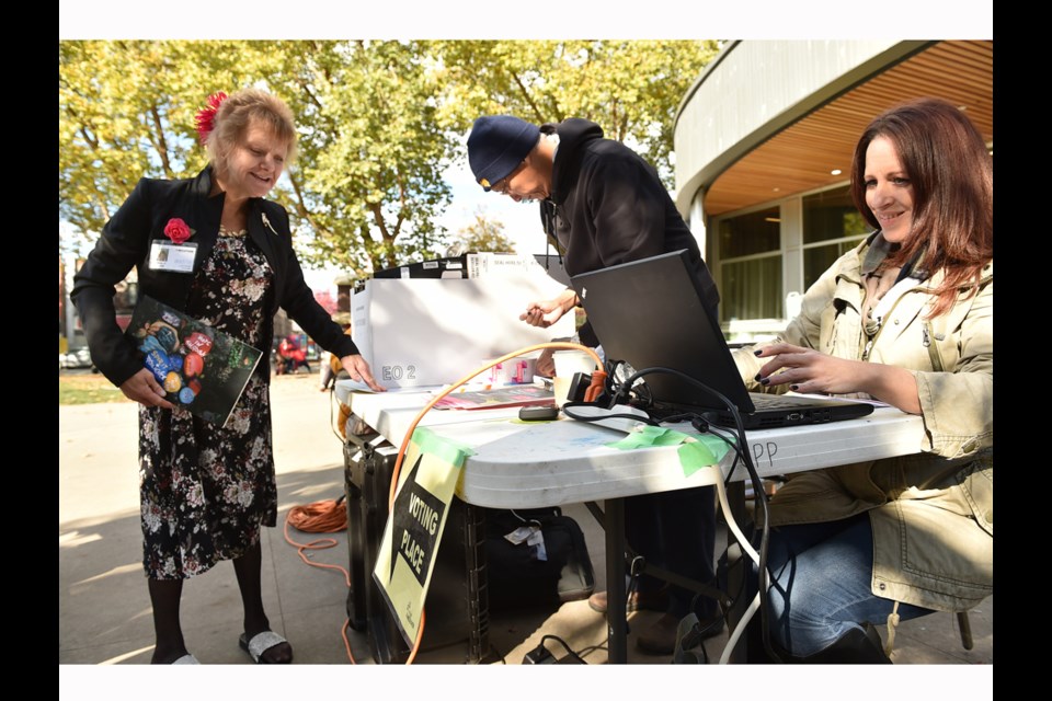 Valeri Fielding signs in at a mobile voting station at Oppenheimer Park on Wednesday. Photo Dan Toulgoet