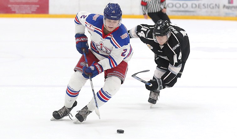 Prince George Spruce Kings defender Layton Ahac speeds past reaching Salmon Arm Silverbacks forward Logan Shaw on Saturday night at Rolling Mix Concrete Arena. Citizen Photo by James Doyle