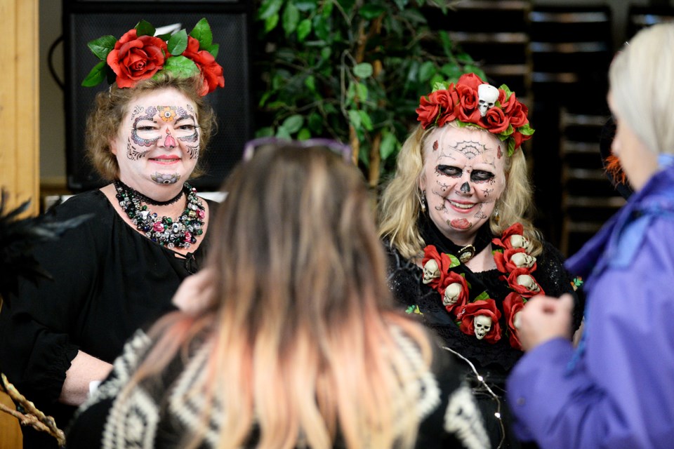 Costumed folks chat with visitors.