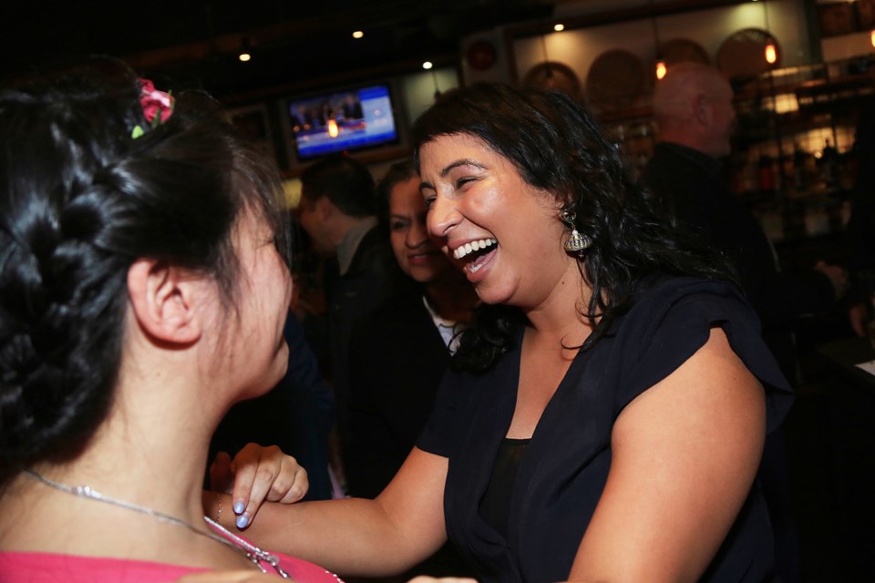 Newly elected trustee Gurveen Dhaliwal celebrates her win Saturday night.