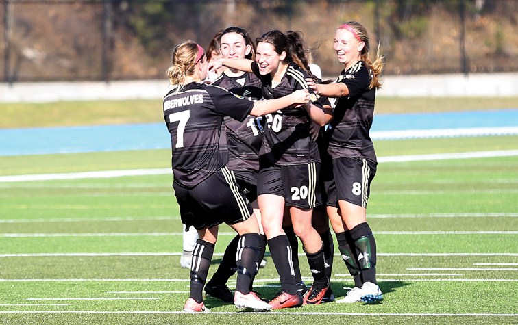 UNBC Timberwolves forward Sofia Jones (#20) is mobbed by teammates after scoring against the UBC Okanagan Heat on Sunday afternoon at Masich Place Stadium. The lone goal clinched a post-season berth for the Timberwolves. Citizen Photo by James Doyle