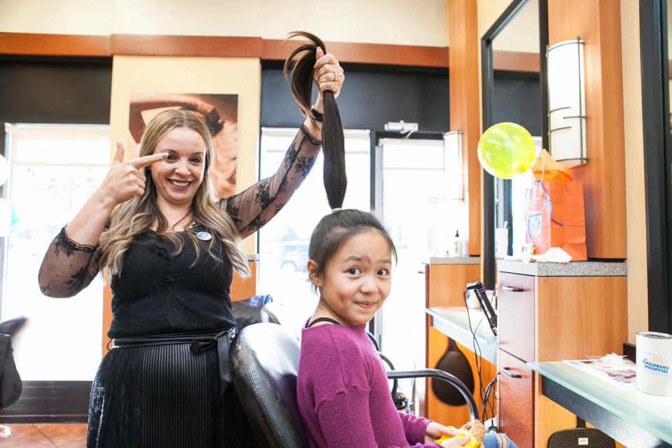Adrienne Ma age 9, a McKinney elementary student, gets set to lose her ponytail for the Wigs for Kids BC event, hosted by Hennessey Hairdo in Richmond Centre. Klutch Photography photos