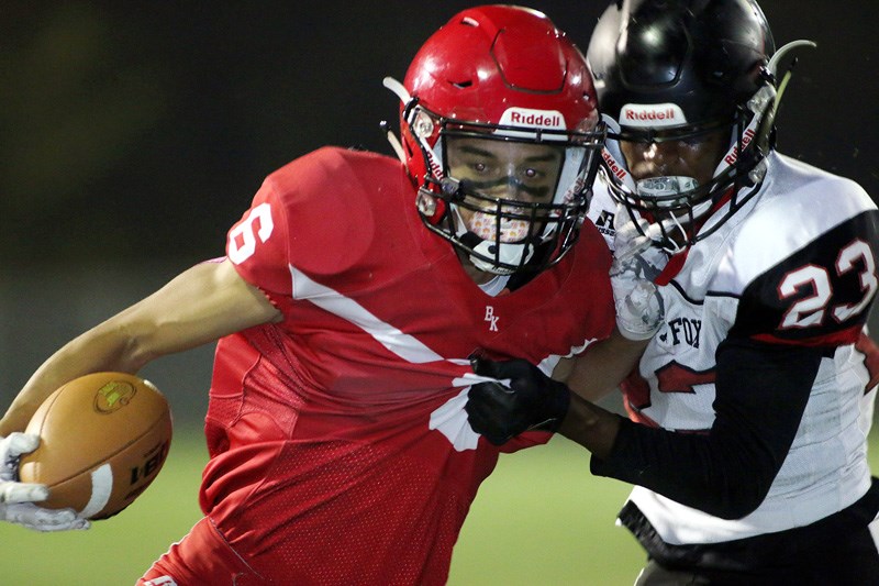 MARIO BARTEL/THE TRI-CITY NEWS
Terry Fox Ravens corner back Jaden Severy grabs hold of St. Thomas More Rickey Parsons late in the first half of their BC Secondary Schools Football Association game, Friday at the Burnaby Lake Sports Complex West.