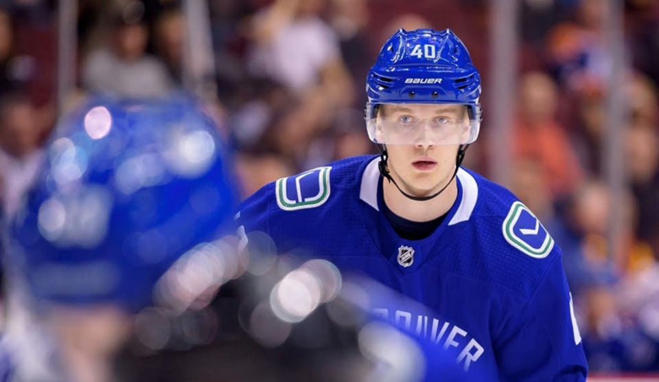 Elias Pettersson looks on during a faceoff