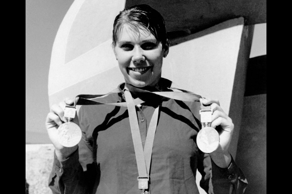 Elaine Tanner poses with her three Olympic medals from the 1968 Mexico City Games. photo Canadian Press/Canadian Olympic Committee