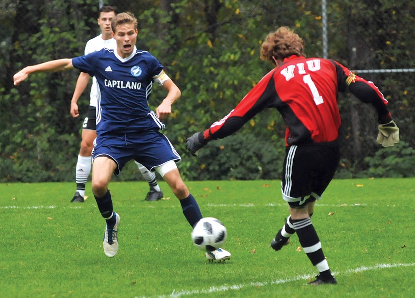 Keith Jackson puts the pressure on during a PacWest game earlier this season against Vancouver Island University. Jackson scored three goals over the weekend as the Blues picked up two wins over VIU to lock up first place in the league. photo Paul McGrath, North Shore News