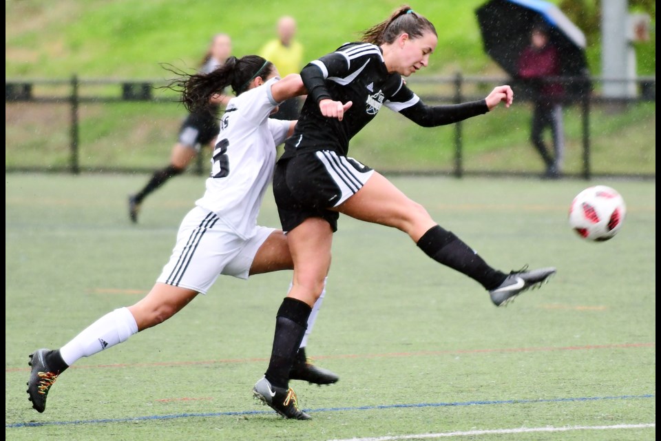Douglas College's Sneha Sandhu, at left, battles Vancouver Island's Kate Reynolds for possession during an early season encounter. The two teams could lock horns again in the PacWest women's soccer final on Saturday, noon at Burnaby Lake West complex, if Douglas prevails Friday in the semifinal.