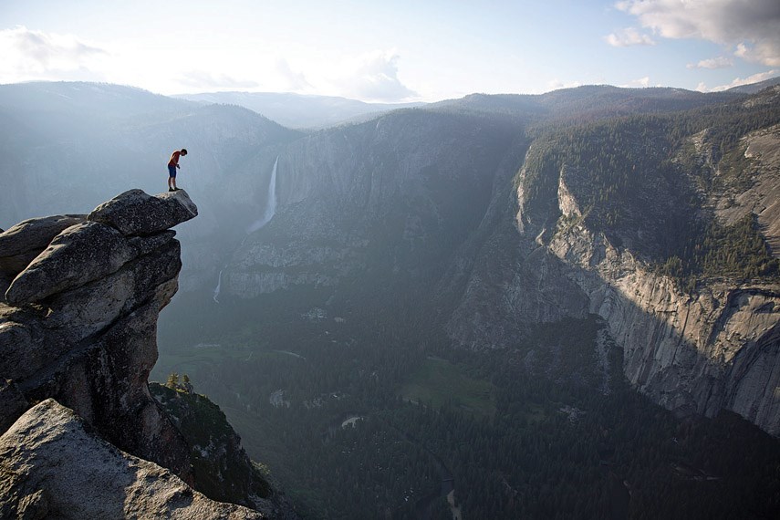 Alex Honnold peers over the edge of Glacier Point in Yosemite National Park in the new documentary Free Solo. He had just climbed 600 metres up from the valley floor.