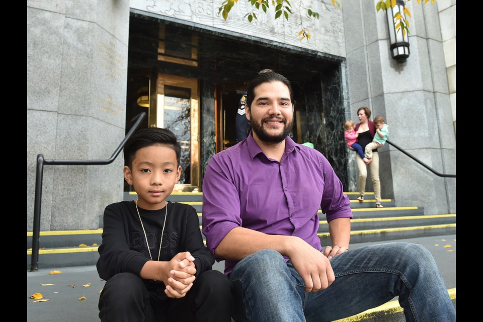 R.J. Pena and Landon Thatcher outside city hall on Friday afternoon. They were recognized for their bravery in the face of an East Vancouver house fire.
