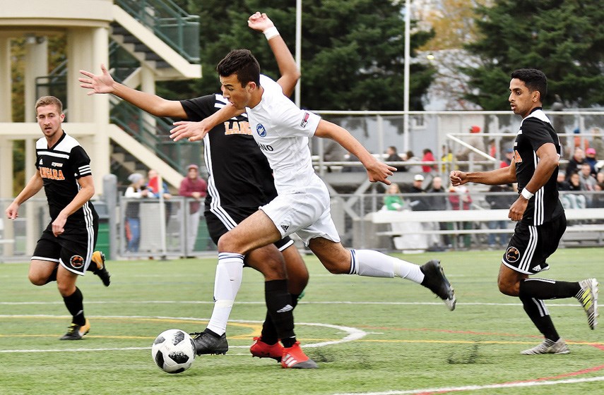 Capilano University’s Marco Favaro charges down the field during the PacWest provincial championship final played Saturday at Burnaby Lake Sports Complex West. The Blues beat the Langara Falcons 2-1 to claim their third provincial title of the past four years. photo Jennifer Gauthier/Burnaby Now