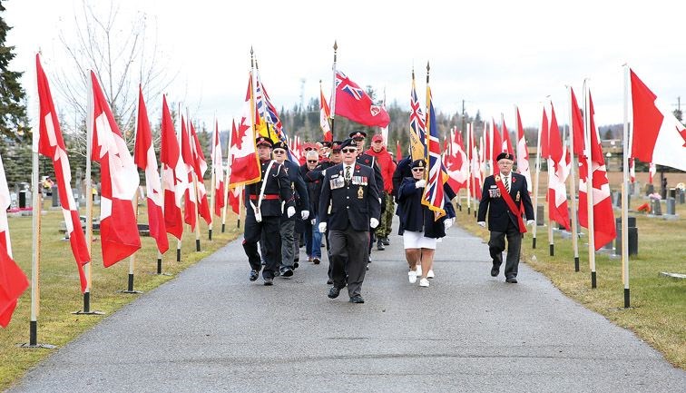 The Royal Canadian Legion Colour Party leads members of the RCMP, Prince George Fire Rescue, the Royal Canadian Legion, Rocky Mountain Rangers, Army Cadets, Sea Cadets, Air Cadets, and Navy League Cadets as they make their way through Memorial Park Cemetery to the Veterans Memorial on Sunday during the Military Church Parade and Veterans Memorial Service.