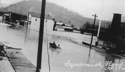 A couple of people use their canoe to get around downtown.