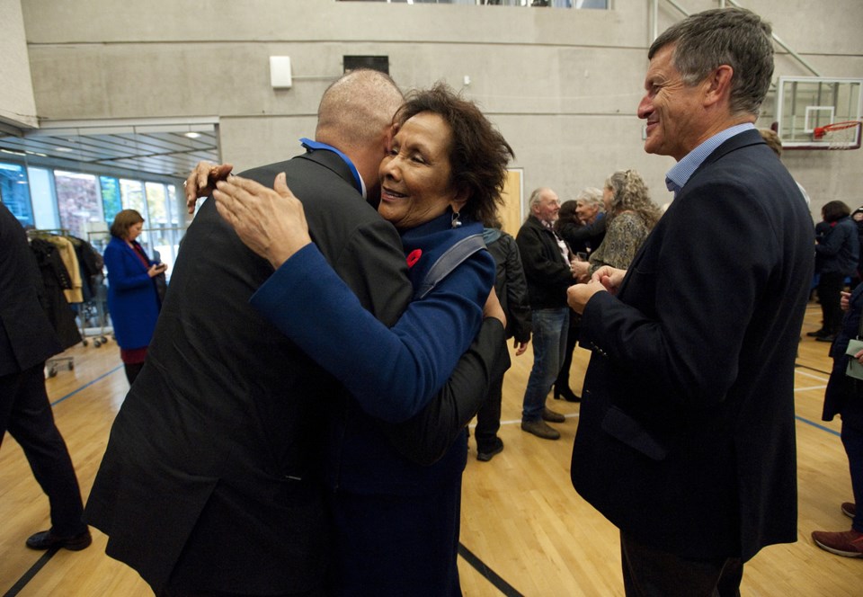 MP Hedy Fry gives her son, Green Party councillor Pete Fry, a hug at Monday's ceremony. Photo Jennif