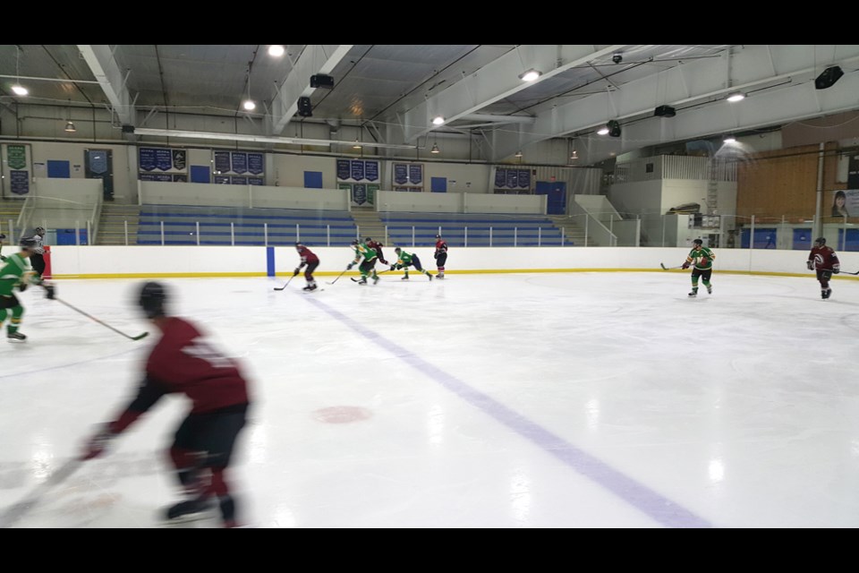 A recent Squamish Men's Hockey League game. The Stars, in green, face off against the Badgers, in red.