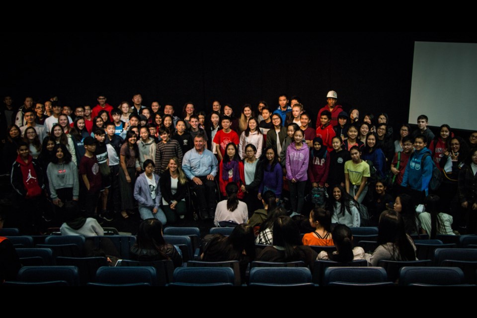 Rick Hansen poses for a photo with students at J.N. Burnett Secondary School. Photo: Cristina Carvalheiro