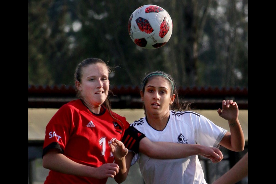 MARIO BARTEL/THE TRI-CITY NEWS
Douglas Royals midfielder Sneha Sandhu battles SAIT Trojans defender Chase O'Brien in their second round match at the Canadian Collegiate Athletic Association women's soccer nationals at Coquitlam's Percy Perry Stadium. Douglas won the match, 4-1.