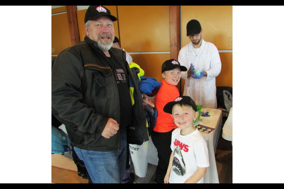 John Adams, with grandsons Fletcher, 9 and Harrison, 6, embrace the hands-on activities available during the free STEAM event held at Exploration Place Saturday.