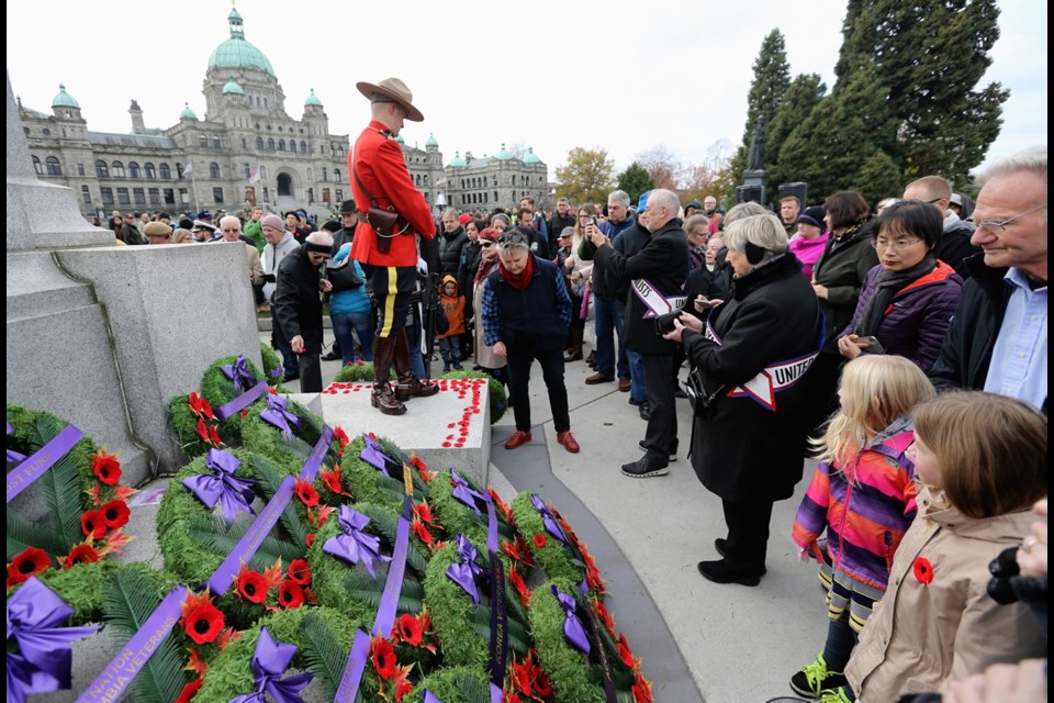 Cenotaph at the legislature is filled with wreaths and poppies as thousands gather for Remembrance Day ceremonies.