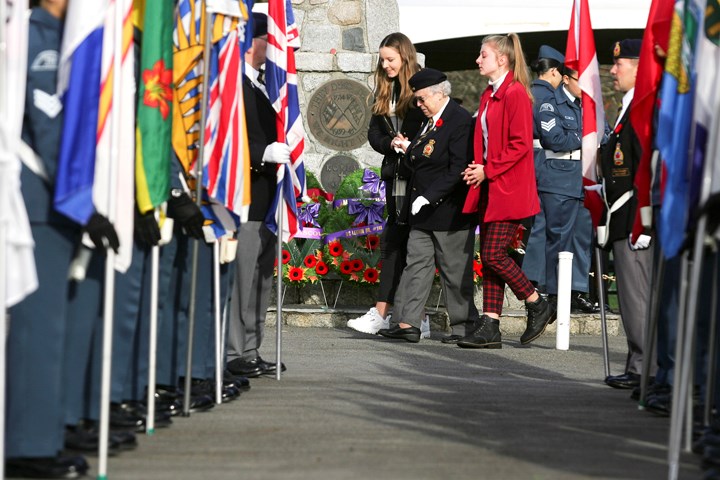 Photograph by Kevin Hill Susan Simpson of Royal Canadian Legion 148 lays a wreath in memory of her husband Brian, a Naval veteran, at the North Burnaby Remembrance Day ceremony in Confederation Park.