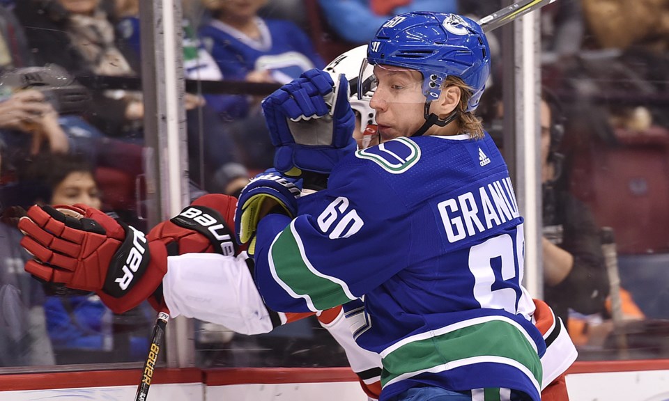 Markus Granlund battles along the boards for the Vancouver Canucks