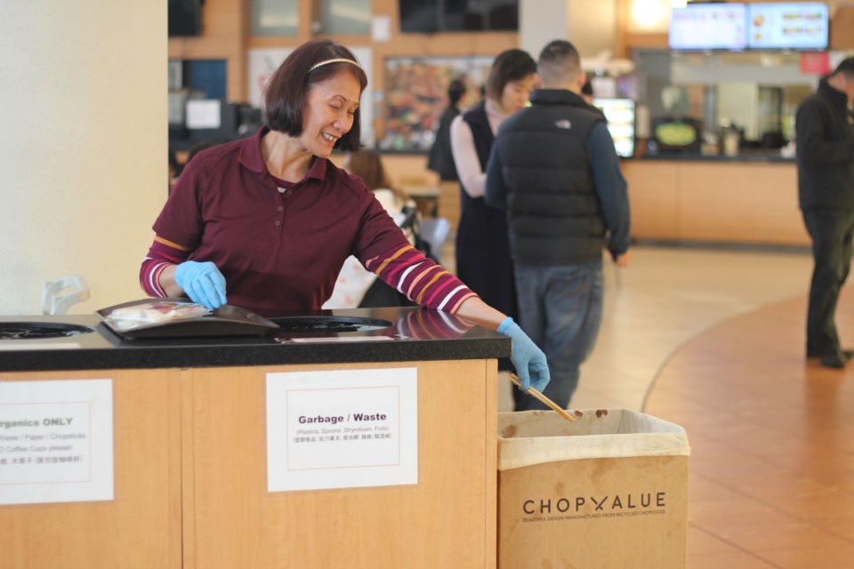 Janitorial staff at Aberdeen Centre help sort chopsticks from food court trays. Photo: Alyse Kotyk