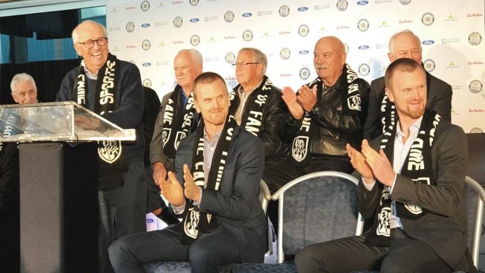 Daniel and Henrik Sedin with Tom Larscheid - BC Sports Hall of Fame