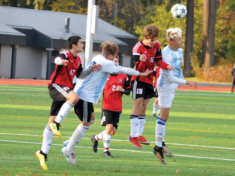 The Alpha Aztecs’ Luca and Stefano Dal Sasso, in white, battle their St. Thomas Aquinas rivals for possession during last week’s B.C. qualifier game.